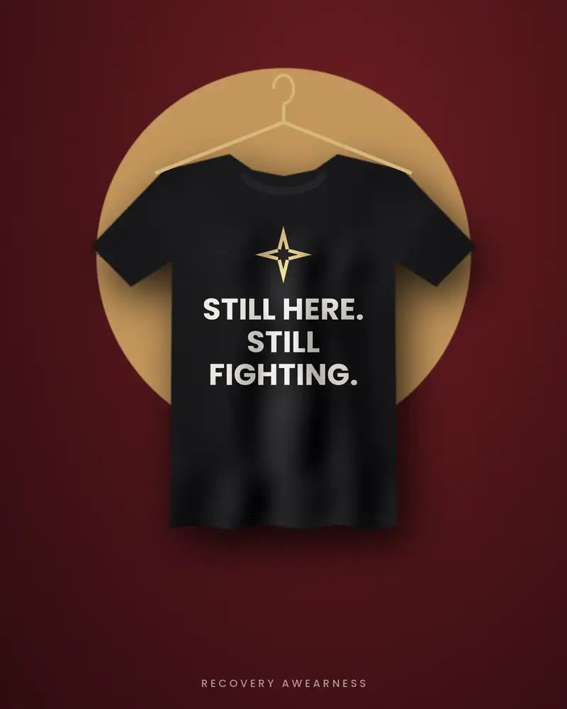 Still Here. Still Fighting. — black tee