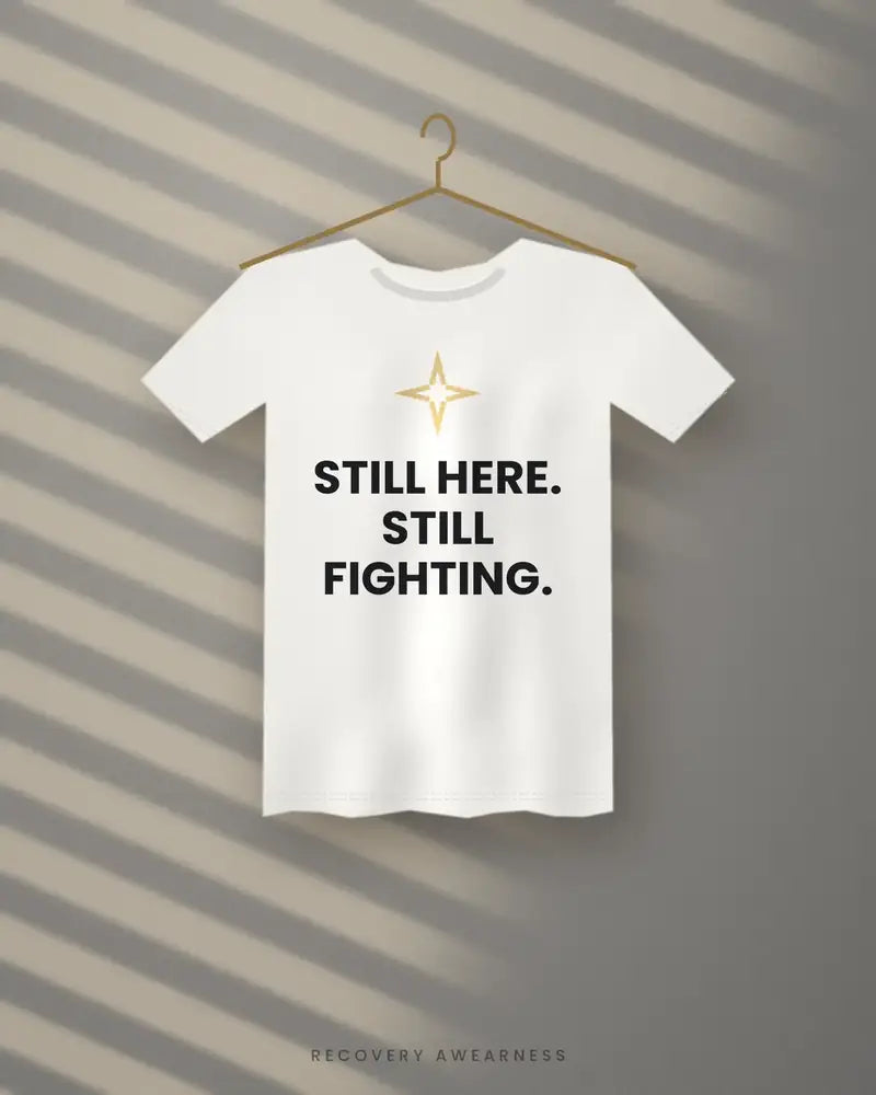 Still Here. Still Fighting. — white tee